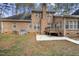 Brick home with a backyard featuring a patio, lawn, and well-maintained landscaping at 4701 Regalwood Dr, Raleigh, NC 27613