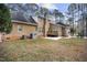 Brick home with a spacious backyard and a wooden deck at 4701 Regalwood Dr, Raleigh, NC 27613