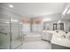 Spacious bathroom with a glass shower, bathtub, and dual vanity sinks at 4701 Regalwood Dr, Raleigh, NC 27613
