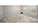 Bright bedroom features neutral carpeting and paint, plus large windows with lovely wooded views at 4701 Regalwood Dr, Raleigh, NC 27613