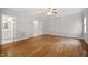 Spacious bedroom with hardwood floors, ceiling fan, and neutral paint at 4701 Regalwood Dr, Raleigh, NC 27613