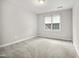 Neutral bedroom featuring plush carpeting and a window offering natural light at 4701 Regalwood Dr, Raleigh, NC 27613