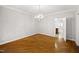 Formal dining room with beautiful hardwood floors and elegant chandelier at 4701 Regalwood Dr, Raleigh, NC 27613