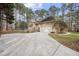 Features a two-car garage, brick exterior, and a long driveway at 4701 Regalwood Dr, Raleigh, NC 27613
