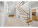 Bright foyer with a staircase, tile flooring, and high ceilings, creating a welcoming entrance at 4701 Regalwood Dr, Raleigh, NC 27613