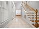 Bright foyer with tile flooring, stairs, high ceilings, and access to other rooms in the house at 4701 Regalwood Dr, Raleigh, NC 27613