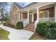Charming brick home with a covered front porch, landscaped garden and brick steps at 4701 Regalwood Dr, Raleigh, NC 27613