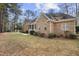 Charming brick home with mature trees and manicured landscaping at 4701 Regalwood Dr, Raleigh, NC 27613