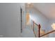 Upstairs hallway with carpet flooring, wood railing, and natural light at 4701 Regalwood Dr, Raleigh, NC 27613