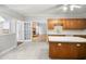 Charming kitchen with wood cabinets and an island with a view of the living room at 4701 Regalwood Dr, Raleigh, NC 27613
