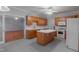 Functional kitchen boasts an island, a ceiling fan, and access to an additional room at 4701 Regalwood Dr, Raleigh, NC 27613