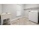 Clean laundry room featuring a washing machine, utility sink, and window at 4701 Regalwood Dr, Raleigh, NC 27613