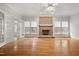 Bright living room features hardwood floors and a classic brick fireplace at 4701 Regalwood Dr, Raleigh, NC 27613