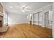 Large living room with brick fireplace, hardwood floors, and built-in shelving at 4701 Regalwood Dr, Raleigh, NC 27613