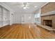 Inviting living room with hardwood floors, built-in bookshelves, and cozy brick fireplace at 4701 Regalwood Dr, Raleigh, NC 27613
