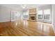 Spacious living room featuring a brick fireplace, hardwood floors, and natural light from large windows at 4701 Regalwood Dr, Raleigh, NC 27613