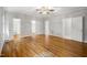 Large primary bedroom with hardwood floors and multiple doorways leading to closet and bath areas at 4701 Regalwood Dr, Raleigh, NC 27613