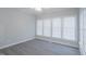 Well-lit sunroom featuring wood-look floors, a ceiling fan and lots of windows with blinds at 4701 Regalwood Dr, Raleigh, NC 27613