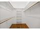Well-organized walk-in closet with custom shelving and hardwood floors at 4701 Regalwood Dr, Raleigh, NC 27613