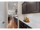 Butlers pantry with quartz countertops and dark cabinets at 6604 Truxton Ln, Raleigh, NC 27616