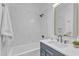 Bright bathroom features white subway tile, dark hardware, and a floating vanity at 1000 Addison Pl # 101, Raleigh, NC 27610