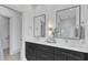 Modern bathroom featuring double vanities, sleek cabinets, and a walk-in shower with glass enclosure at 1000 Addison Pl # 101, Raleigh, NC 27610