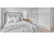 Comfortable bedroom featuring a metal bed frame, soft gray bedding, and warm wooden floors at 1000 Addison Pl # 101, Raleigh, NC 27610