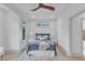 Bright bedroom with modern decor, large windows, and a comfortable bed with decorative pillows at 1000 Addison Pl # 101, Raleigh, NC 27610