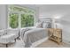 Bright bedroom with a cozy metal bed, a wooden nightstand, and a large window view at 1000 Addison Pl # 101, Raleigh, NC 27610