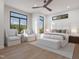 Bright bedroom with a large bed, seating area, and modern ceiling fan at 1000 Addison Pl # 101, Raleigh, NC 27610