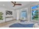 Bright bedroom featuring a modern ceiling fan, large windows, and a cozy sitting area at 1000 Addison Pl # 101, Raleigh, NC 27610