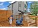 Relaxing deck with blue chairs, a small table, and view of the gray two-story house at 1000 Addison Pl # 101, Raleigh, NC 27610