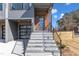 Stylish entrance with gray stone steps, a black railing, and a modern door with glass panes at 1000 Addison Pl # 101, Raleigh, NC 27610