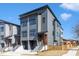 Contemporary gray townhomes with clean lines, black framed windows, and individual garage entrances at 1000 Addison Pl # 101, Raleigh, NC 27610