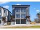 Modern townhomes showcase gray siding, black framed windows, and garage parking at 1000 Addison Pl # 101, Raleigh, NC 27610