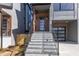 Modern townhome showcases an inviting entrance with stone stairs and steel railings at 1000 Addison Pl # 101, Raleigh, NC 27610
