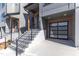 Modern townhome boasts a stylish entrance with steel railings and attached garage at 1000 Addison Pl # 101, Raleigh, NC 27610