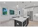 Open kitchen design with a large island, stainless steel appliances, and a view of the dining area at 1000 Addison Pl # 101, Raleigh, NC 27610