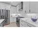 Modern white kitchen featuring stainless steel appliances, sleek cabinets, and a stylish backsplash at 1000 Addison Pl # 101, Raleigh, NC 27610