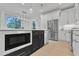 Modern kitchen featuring stainless steel appliances, black island with countertop seating, and sleek white cabinets at 1000 Addison Pl # 101, Raleigh, NC 27610
