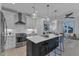 Modern kitchen featuring white cabinets, stainless steel appliances, and a large island with bar seating at 1000 Addison Pl # 101, Raleigh, NC 27610