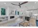 Open concept living room with a modern fireplace, large windows, and seamless flow into the dining area at 1000 Addison Pl # 101, Raleigh, NC 27610
