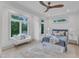 A bedroom with a queen size bed and large windows looks out over the trees at 1000 Addison Pl # 102, Raleigh, NC 27610