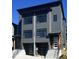 Modern two-story exterior showing gray facade, black framed windows, and paired entryways at 1000 Addison Pl # 102, Raleigh, NC 27610