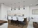 Open-concept kitchen with white cabinetry, an island with bar seating, and stainless steel appliances at 1000 Addison Pl # 102, Raleigh, NC 27610