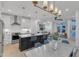Open-concept kitchen with an island, stainless steel appliances, and dining area with contemporary lighting at 1000 Addison Pl # 102, Raleigh, NC 27610