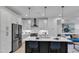 Bright kitchen with white cabinets, stainless steel appliances, and a central island with bar seating at 1000 Addison Pl # 102, Raleigh, NC 27610