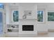 Living room with fireplace and a large window showcases natural light and built-in shelving at 1000 Addison Pl # 102, Raleigh, NC 27610