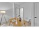 Well-lit office with wood desk, white chairs, decorative art, and a door leading to another room at 1000 Addison Pl # 102, Raleigh, NC 27610