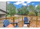 The wooden deck has blue Adirondack chairs overlooking a neighborhood street at 1000 Addison Pl # 102, Raleigh, NC 27610